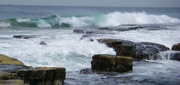 Ocean waves breaking against a rocky coast